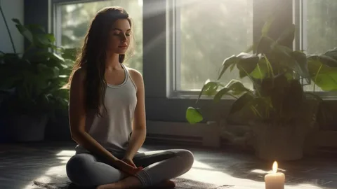 Sportlerin sitzt meditierend im Schneidersitz vor einer Kerze, Symbol für Psychologie im Sport für Entspannung und achtsame Regeneration.